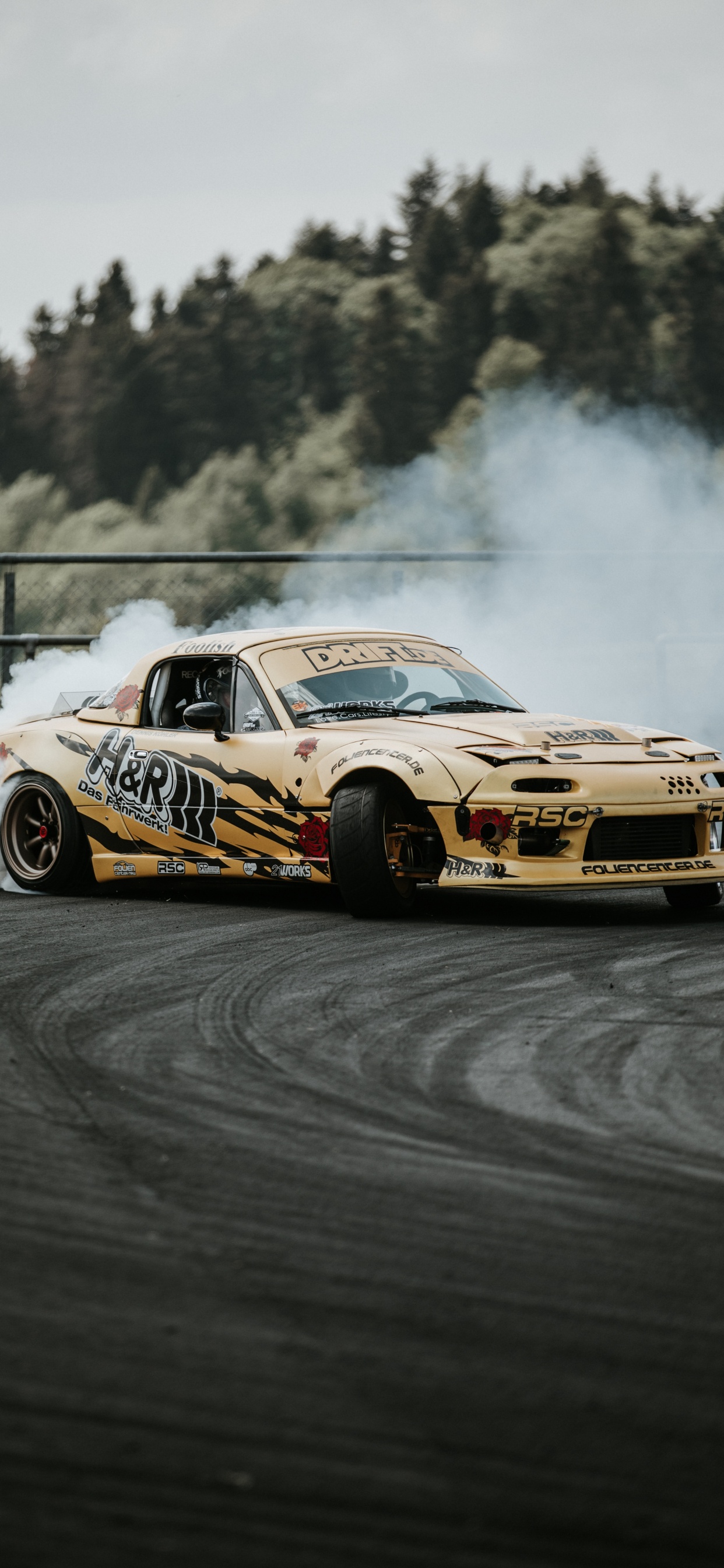 Yellow and Black Chevrolet Camaro on Track. Wallpaper in 1242x2688 Resolution