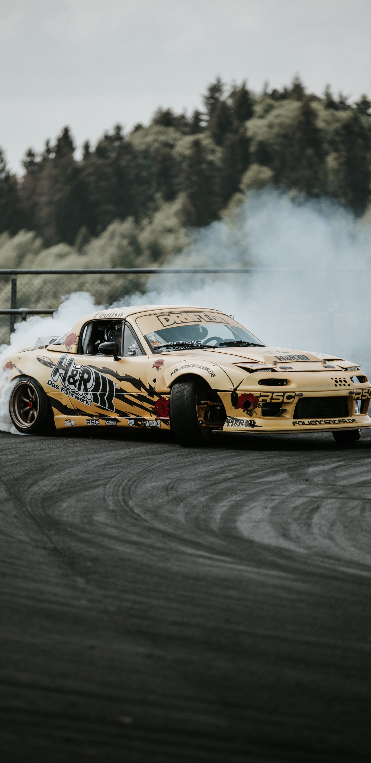 Yellow and Black Chevrolet Camaro on Track. Wallpaper in 1440x2960 Resolution