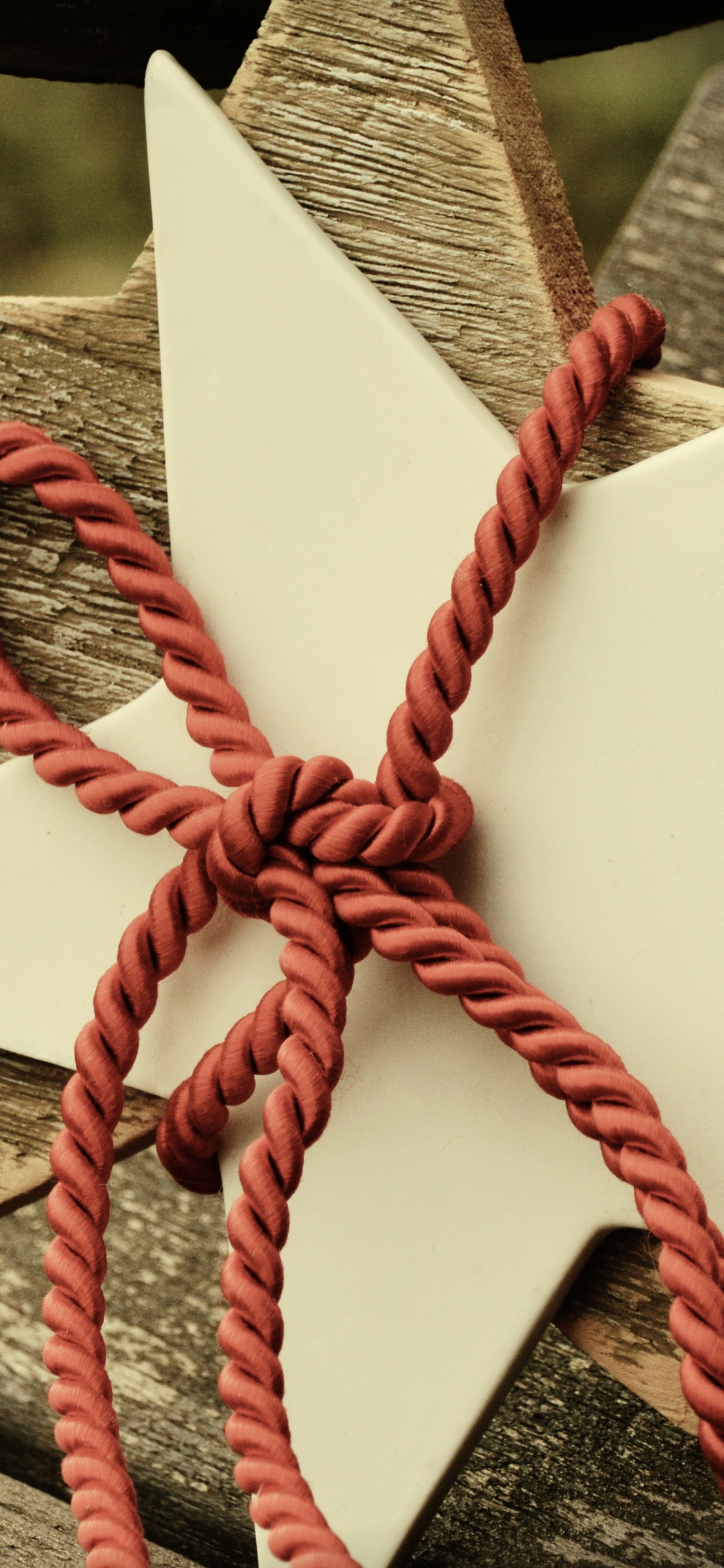 White and Red Ribbon on Brown Wooden Plank. Wallpaper in 1125x2436 Resolution