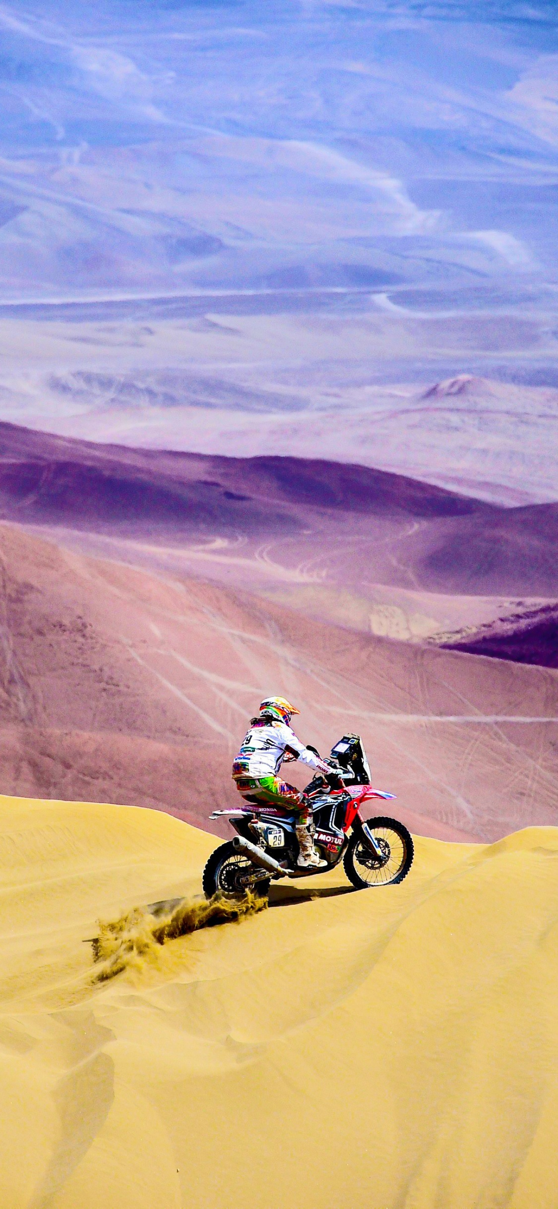 Man Riding Motocross Dirt Bike on Desert During Daytime. Wallpaper in 1125x2436 Resolution