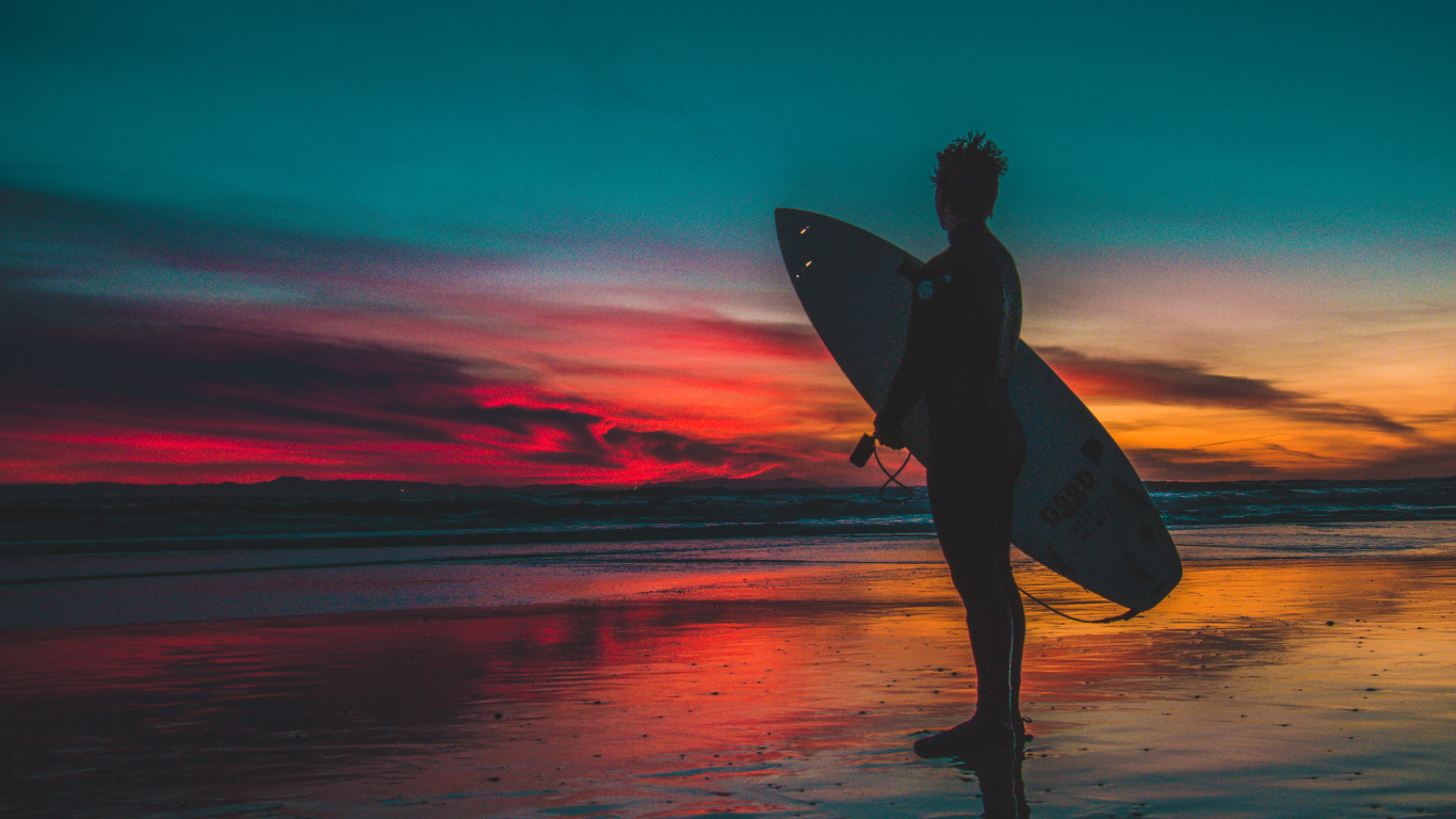 Silhouette of Woman Holding Surfboard on Beach During Sunset. Wallpaper in 1366x768 Resolution