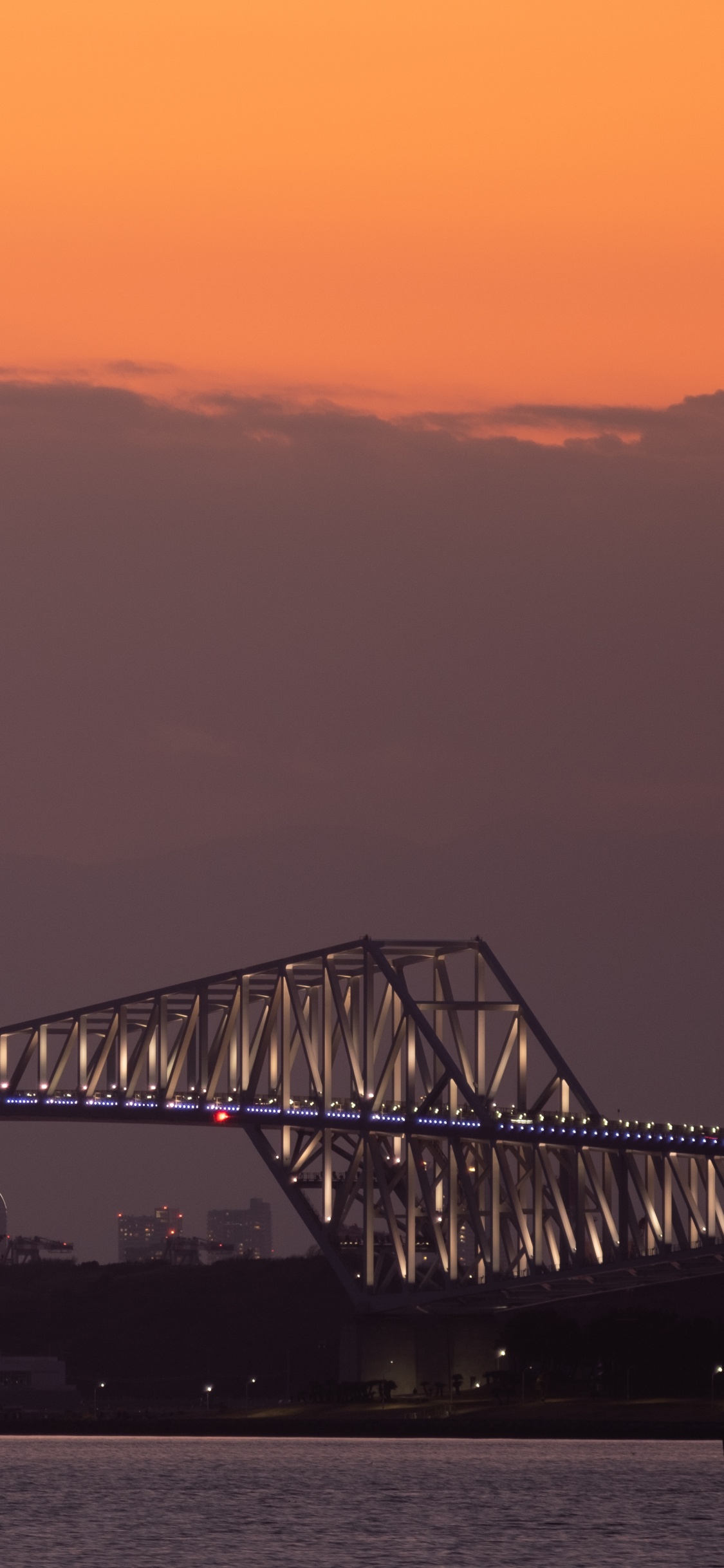 White Metal Bridge Over The Sea During Sunset. Wallpaper in 1125x2436 Resolution