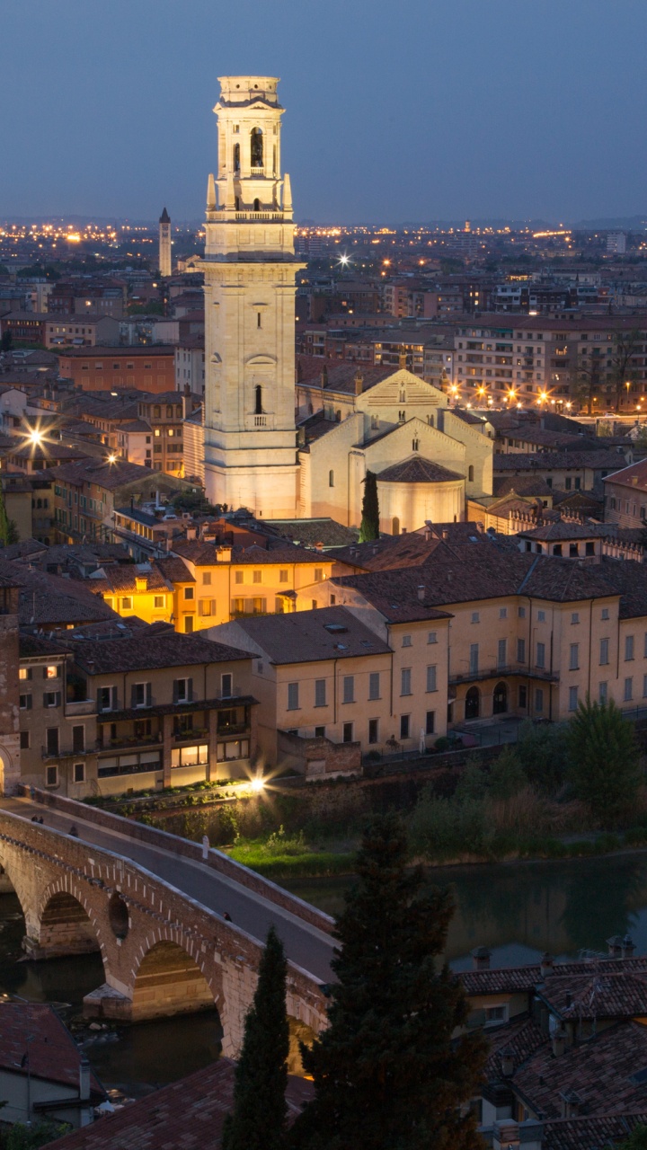 White and Brown Concrete Building Near Body of Water During Night Time. Wallpaper in 720x1280 Resolution