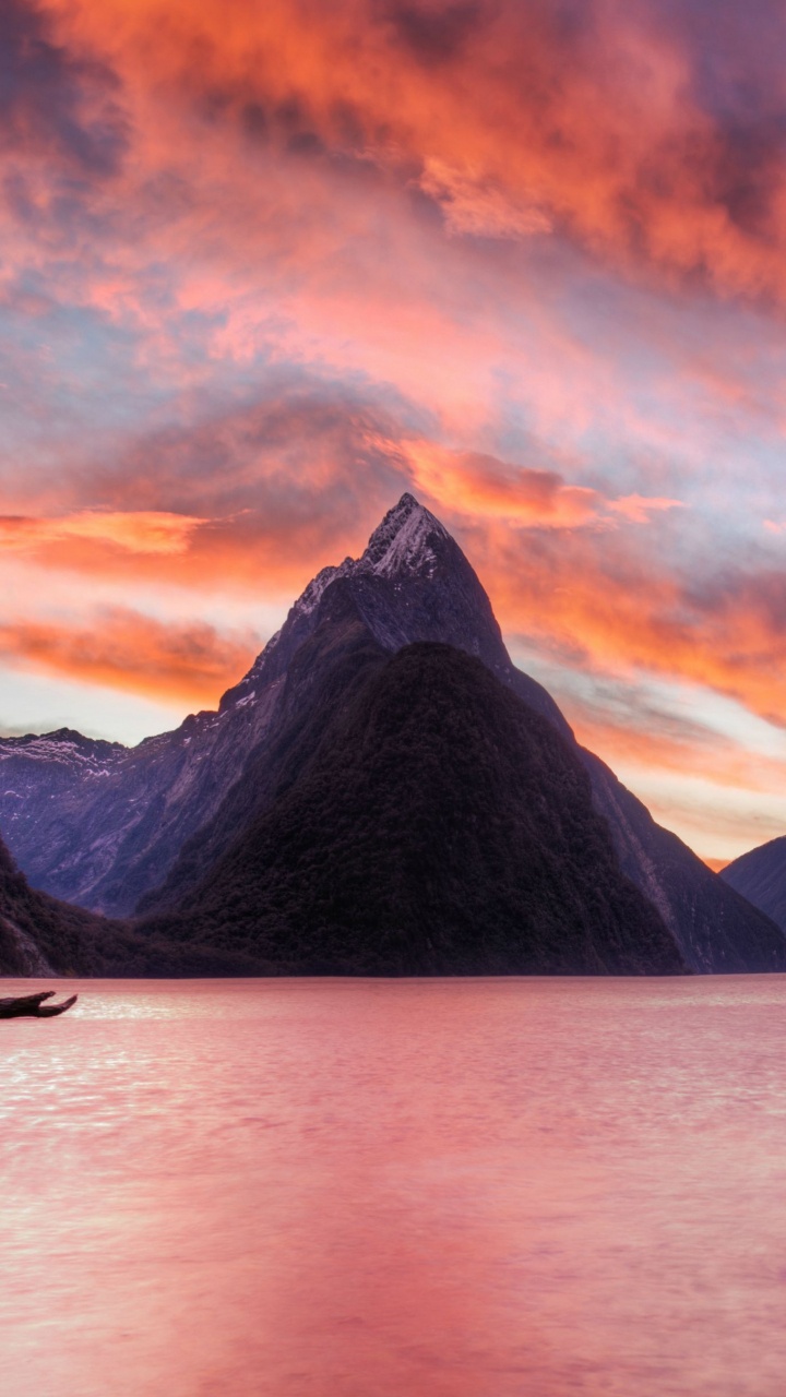 Body of Water Near Mountain During Sunset. Wallpaper in 720x1280 Resolution