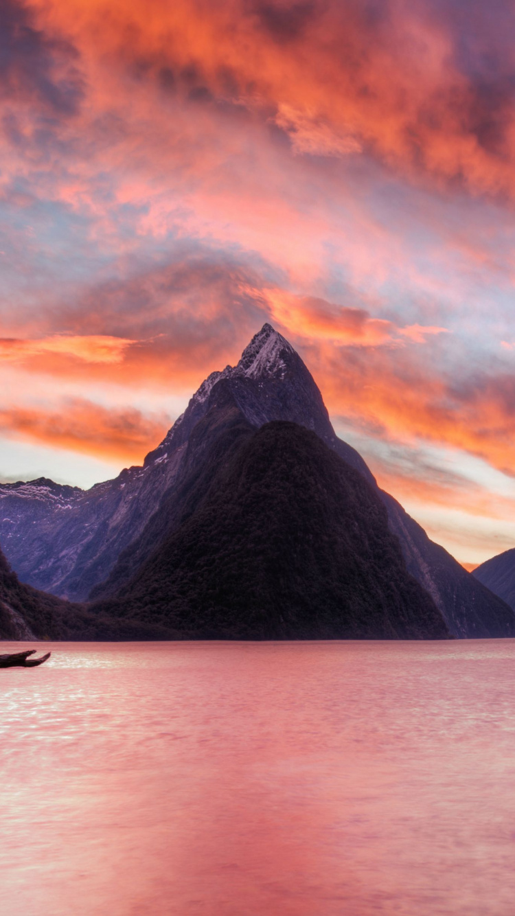 Body of Water Near Mountain During Sunset. Wallpaper in 750x1334 Resolution
