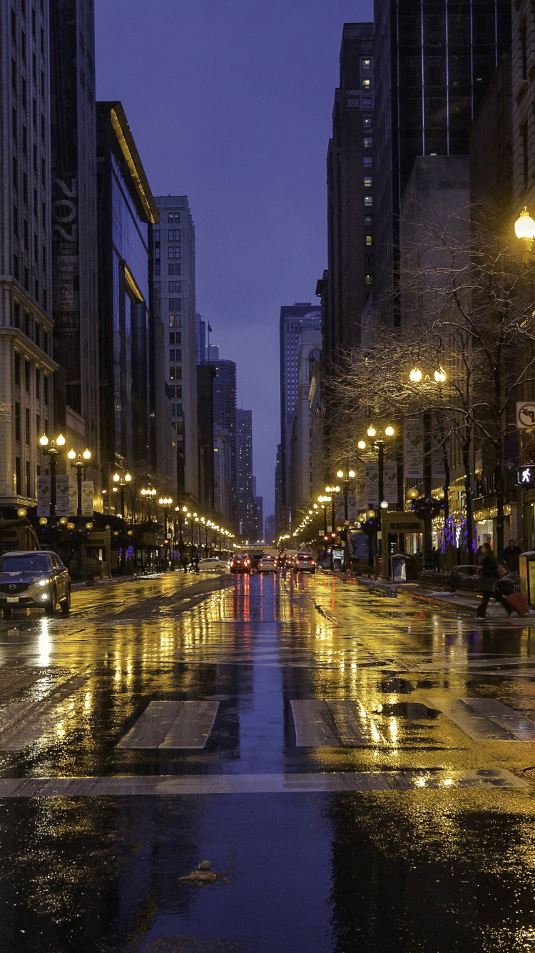Cars on Road Between High Rise Buildings During Night Time. Wallpaper in 750x1334 Resolution