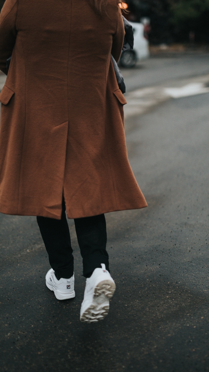Person in Brown Coat and Black Pants Wearing White Sneakers. Wallpaper in 720x1280 Resolution