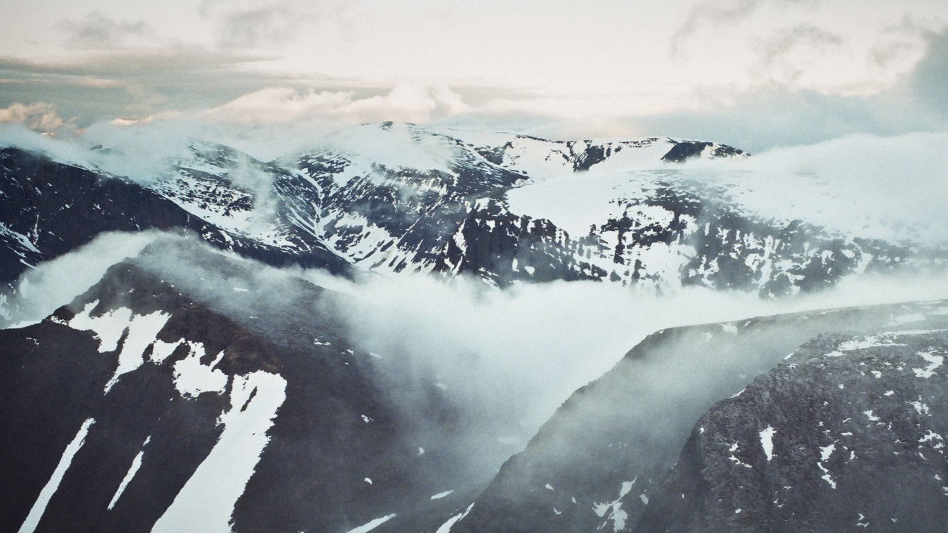 Snow Covered Mountain Under Cloudy Sky During Daytime. Wallpaper in 1366x768 Resolution