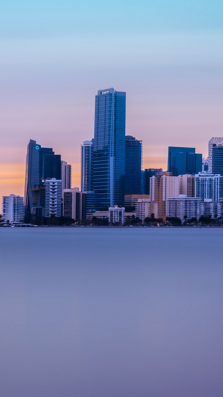 City Skyline Across Body of Water During Daytime. Wallpaper in 750x1334 Resolution