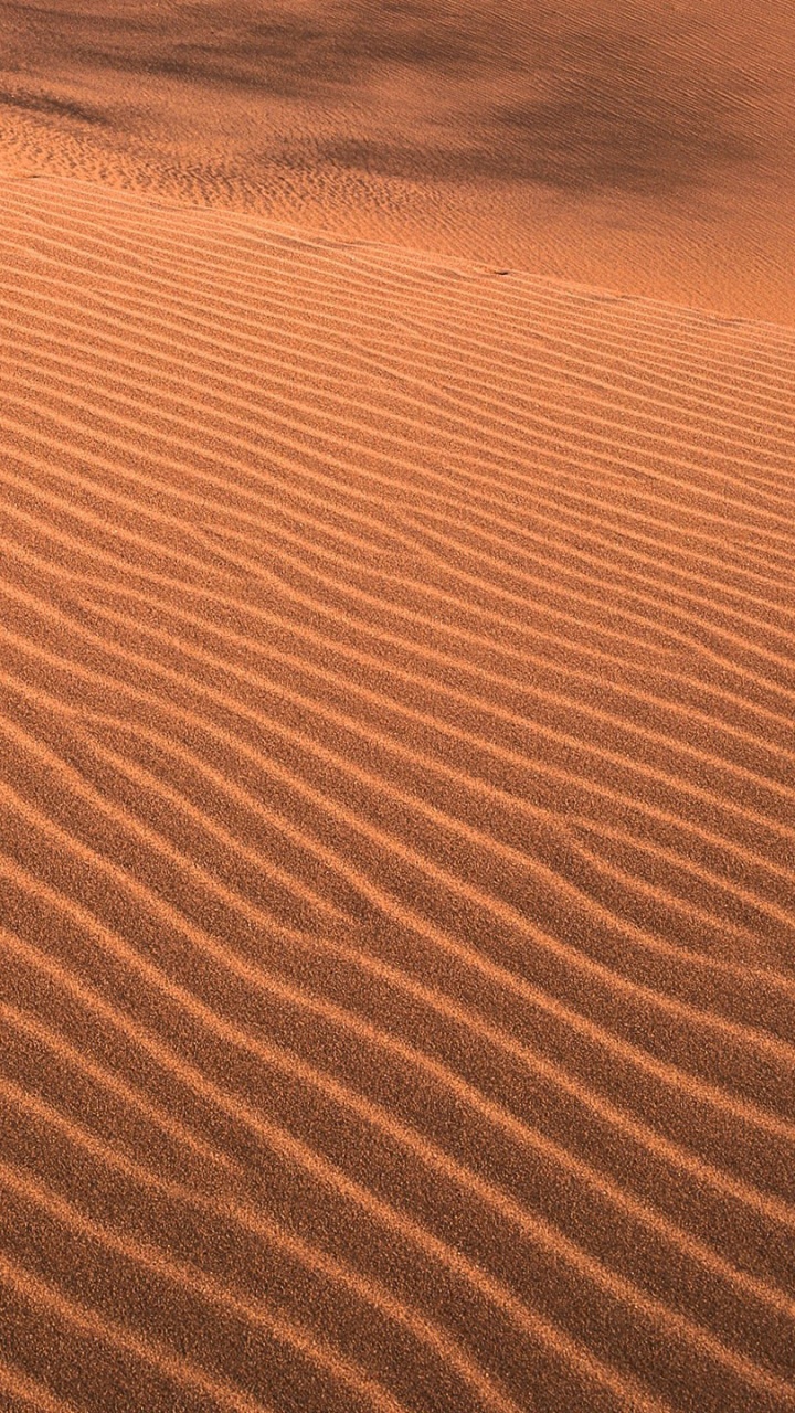 Brown Sand With Blue Water. Wallpaper in 720x1280 Resolution