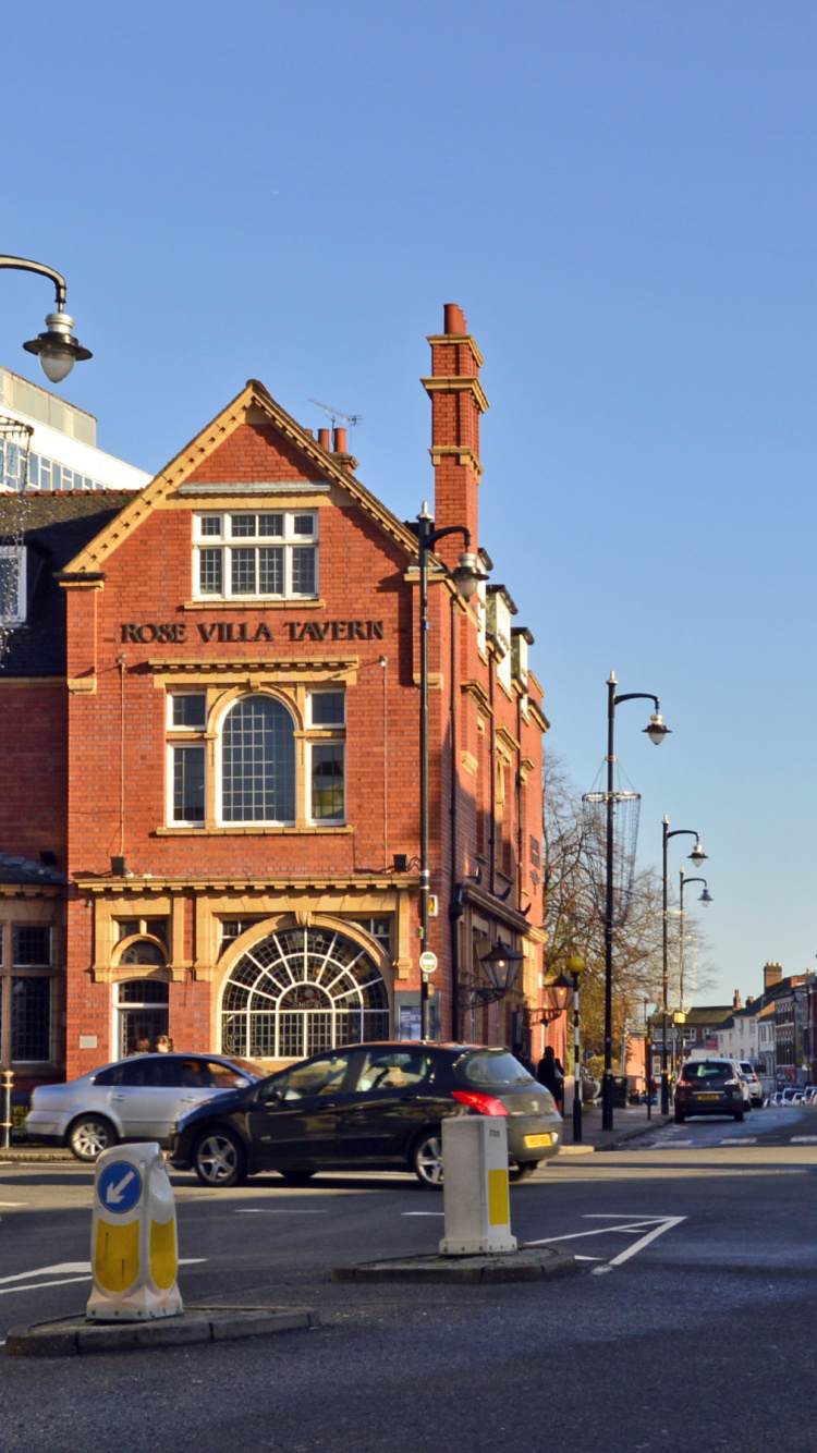 Cars Parked on Street Near Brown Concrete Building During Daytime. Wallpaper in 750x1334 Resolution