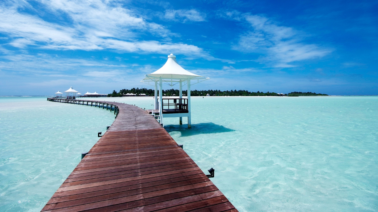 Brown Wooden Dock on Body of Water Under Blue Sky During Daytime. Wallpaper in 1280x720 Resolution