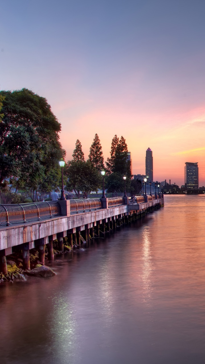 City Skyline Across Body of Water During Night Time. Wallpaper in 720x1280 Resolution