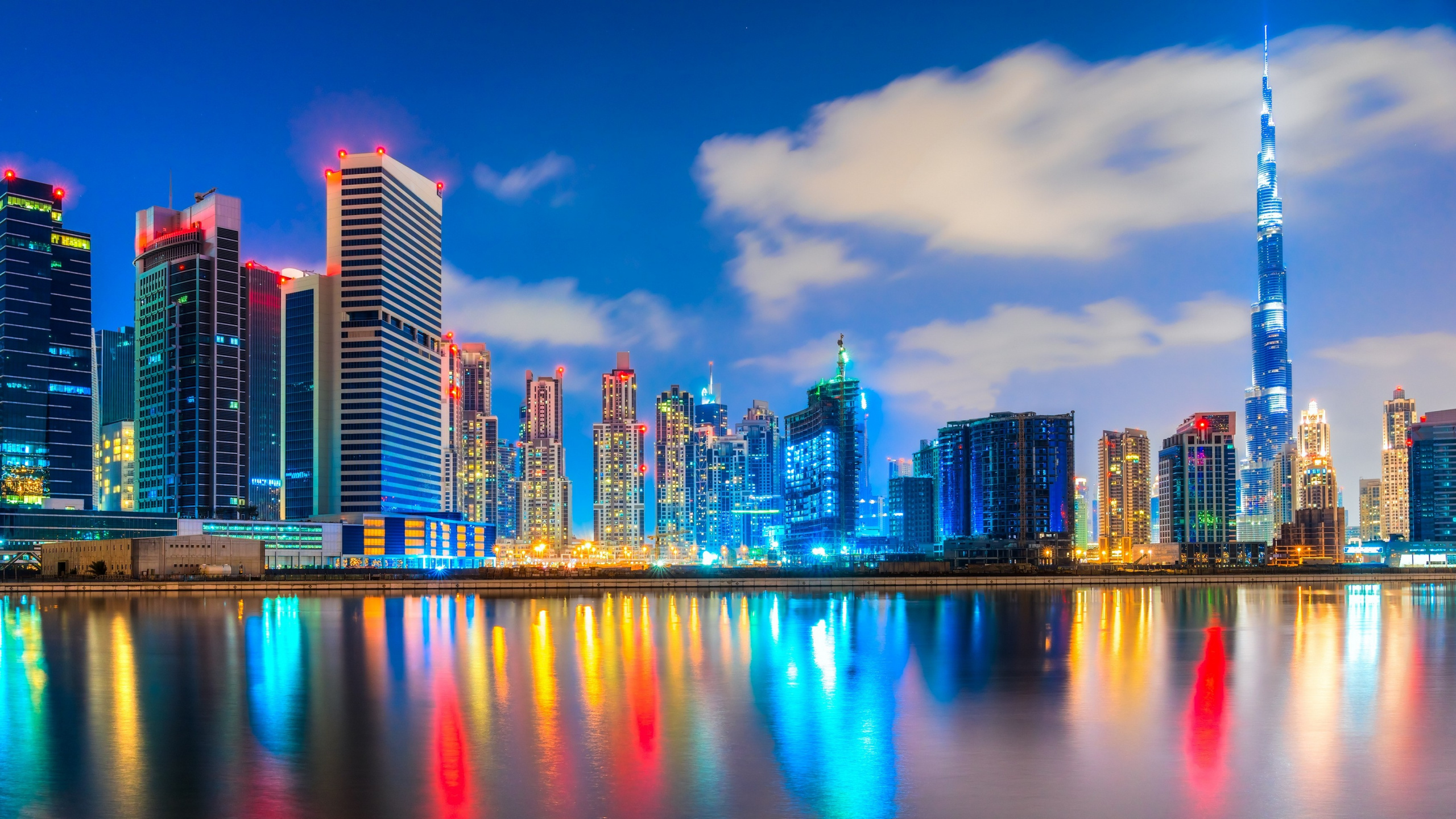 City Skyline Across Body of Water During Night Time. Wallpaper in 2560x1440 Resolution