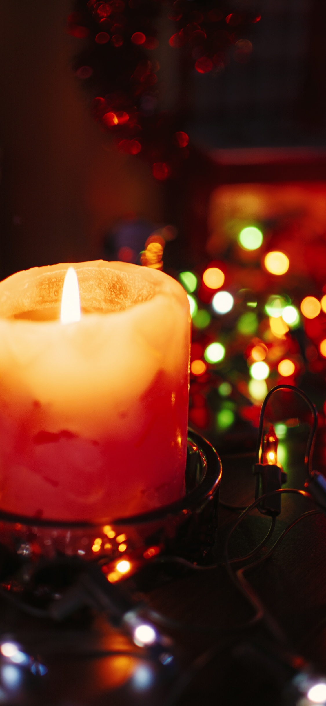 Lighted Candle on Black Metal Candle Holder. Wallpaper in 1125x2436 Resolution