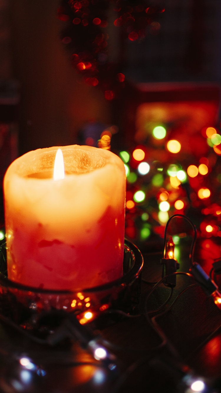 Lighted Candle on Black Metal Candle Holder. Wallpaper in 750x1334 Resolution