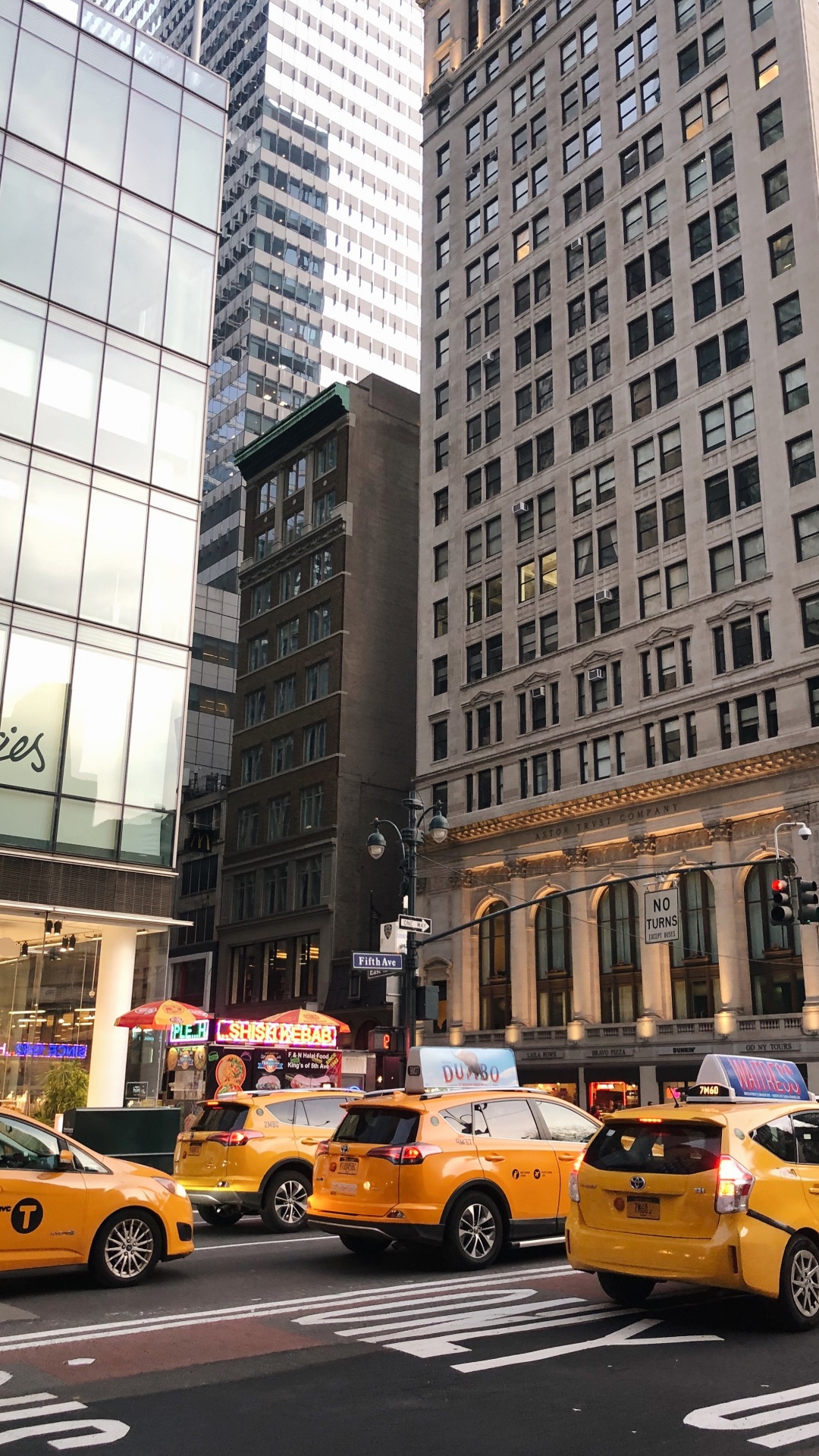Yellow Taxi Cab on Road Near High Rise Building During Daytime. Wallpaper in 1080x1920 Resolution