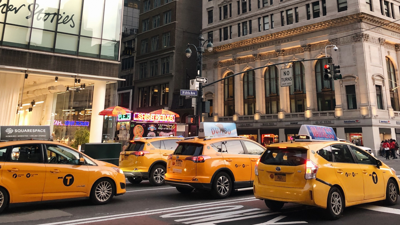 Yellow Taxi Cab on Road Near High Rise Building During Daytime. Wallpaper in 1366x768 Resolution