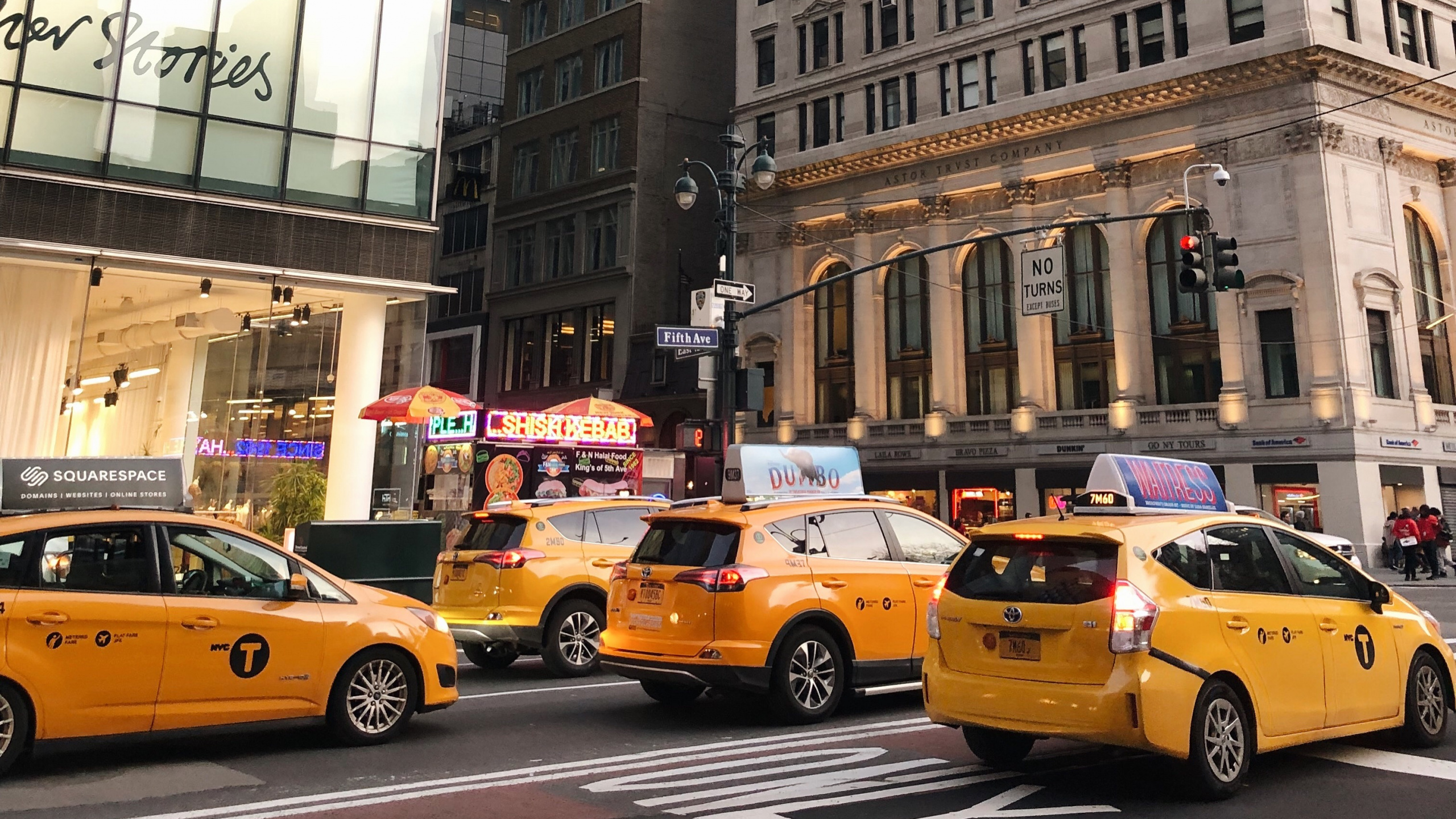 Yellow Taxi Cab on Road Near High Rise Building During Daytime. Wallpaper in 2560x1440 Resolution