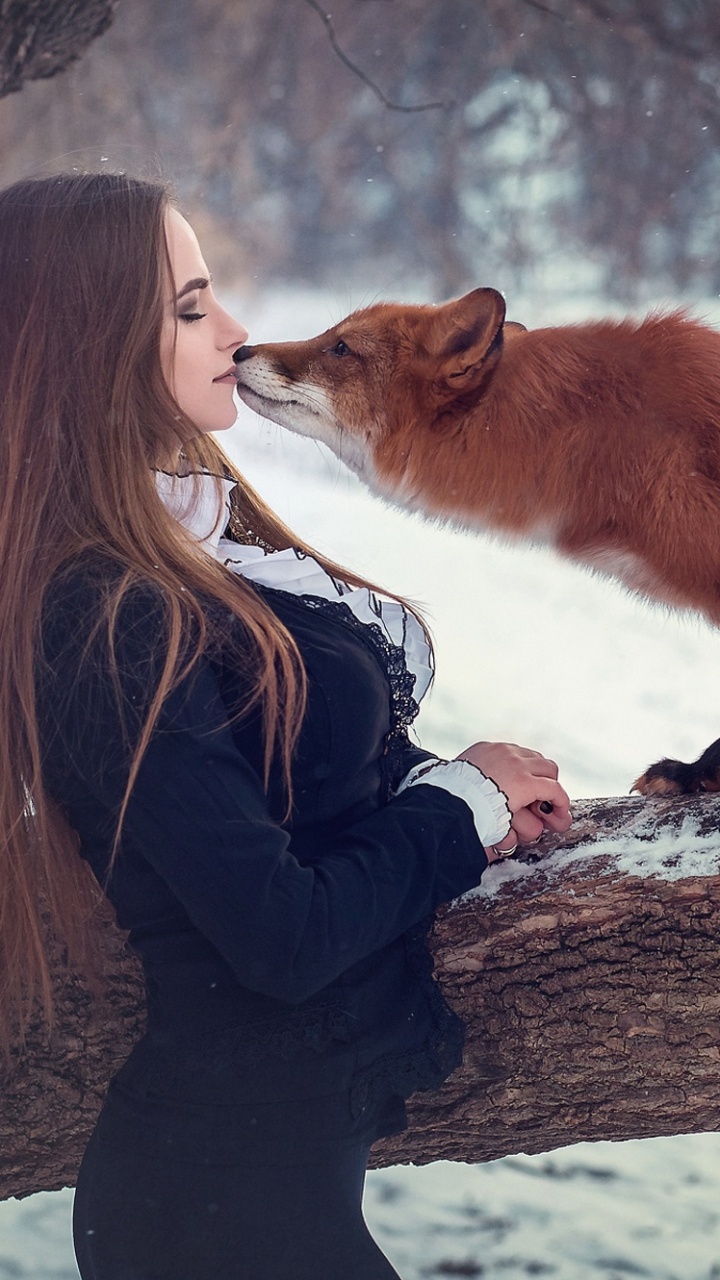 Man in Black Jacket and Brown Fox on Snow Covered Ground During Daytime. Wallpaper in 720x1280 Resolution