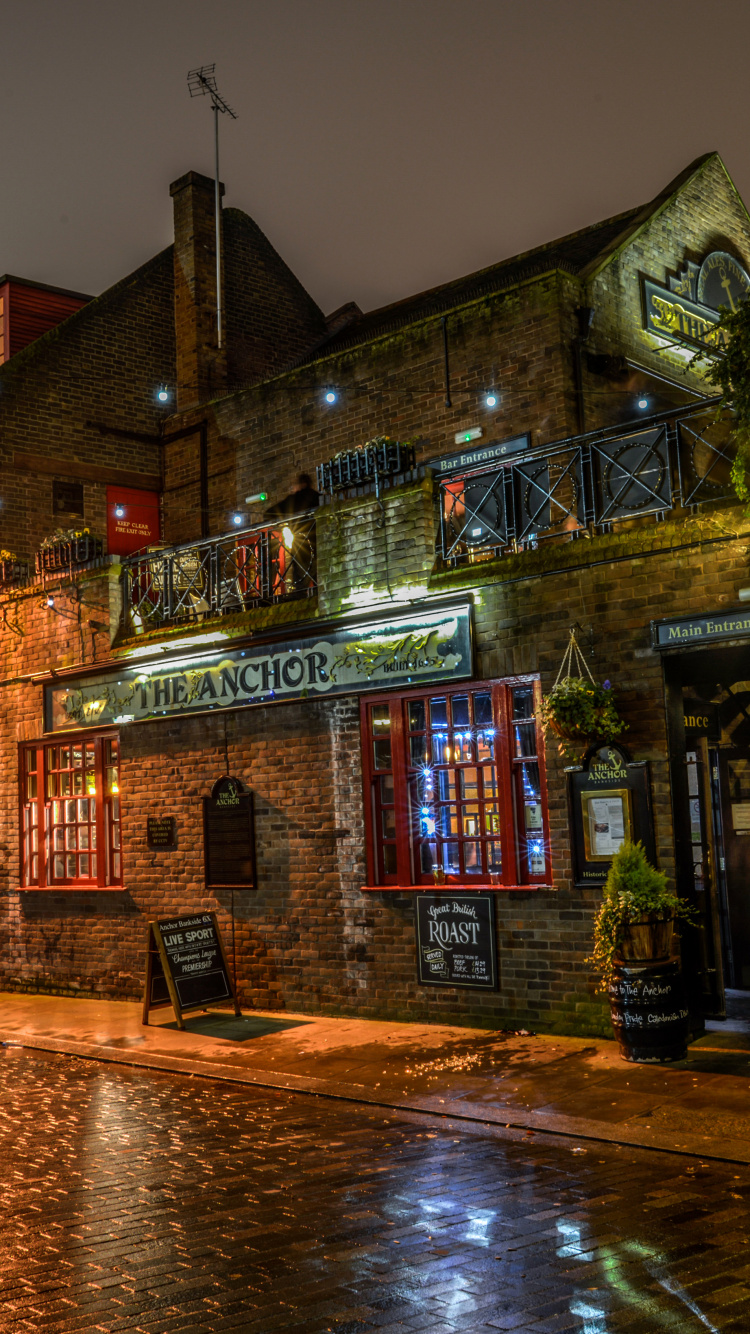 Braunes Und Beiges Betongebäude Während Der Nacht. Wallpaper in 750x1334 Resolution