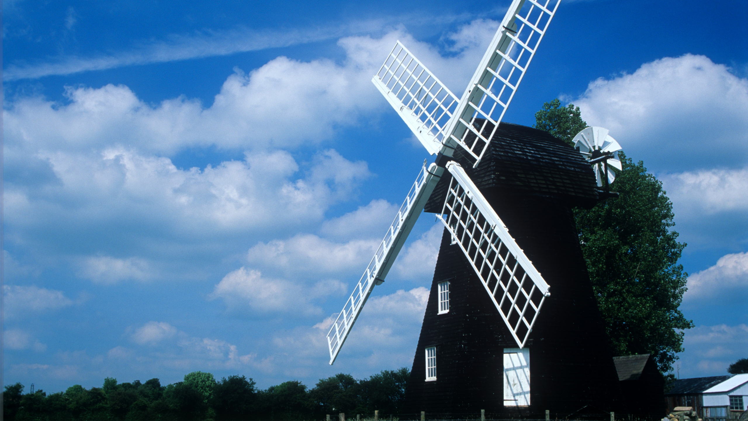 Black and White Windmill Under Blue Sky. Wallpaper in 2560x1440 Resolution