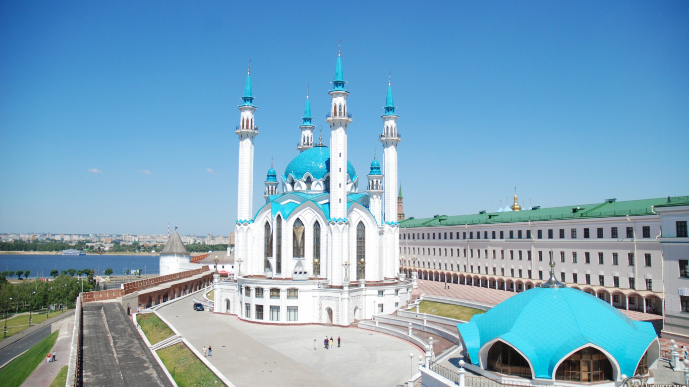 White and Green Concrete Building Under Blue Sky During Daytime. Wallpaper in 1366x768 Resolution