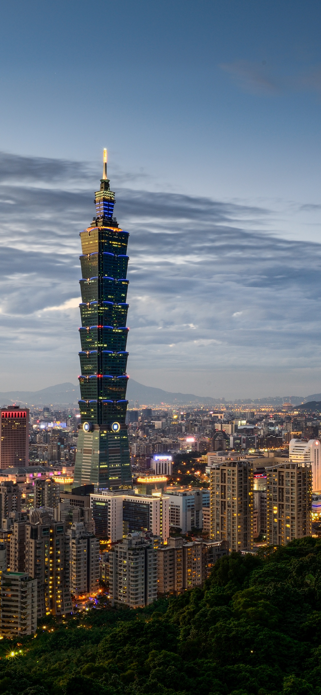 City Skyline Under Blue Sky During Night Time. Wallpaper in 1125x2436 Resolution
