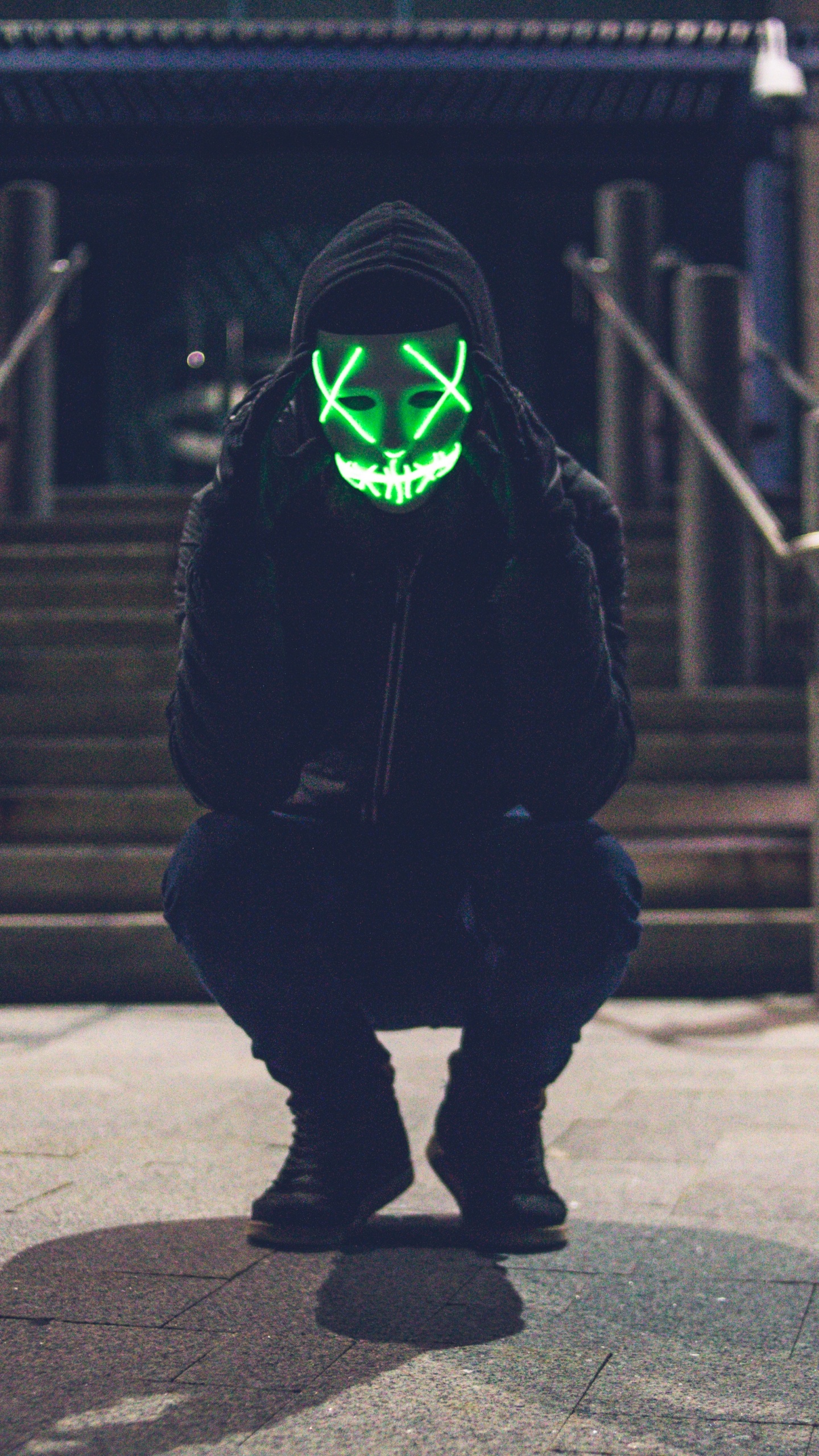 Person in Black Hoodie Wearing Green Mask. Wallpaper in 1440x2560 Resolution