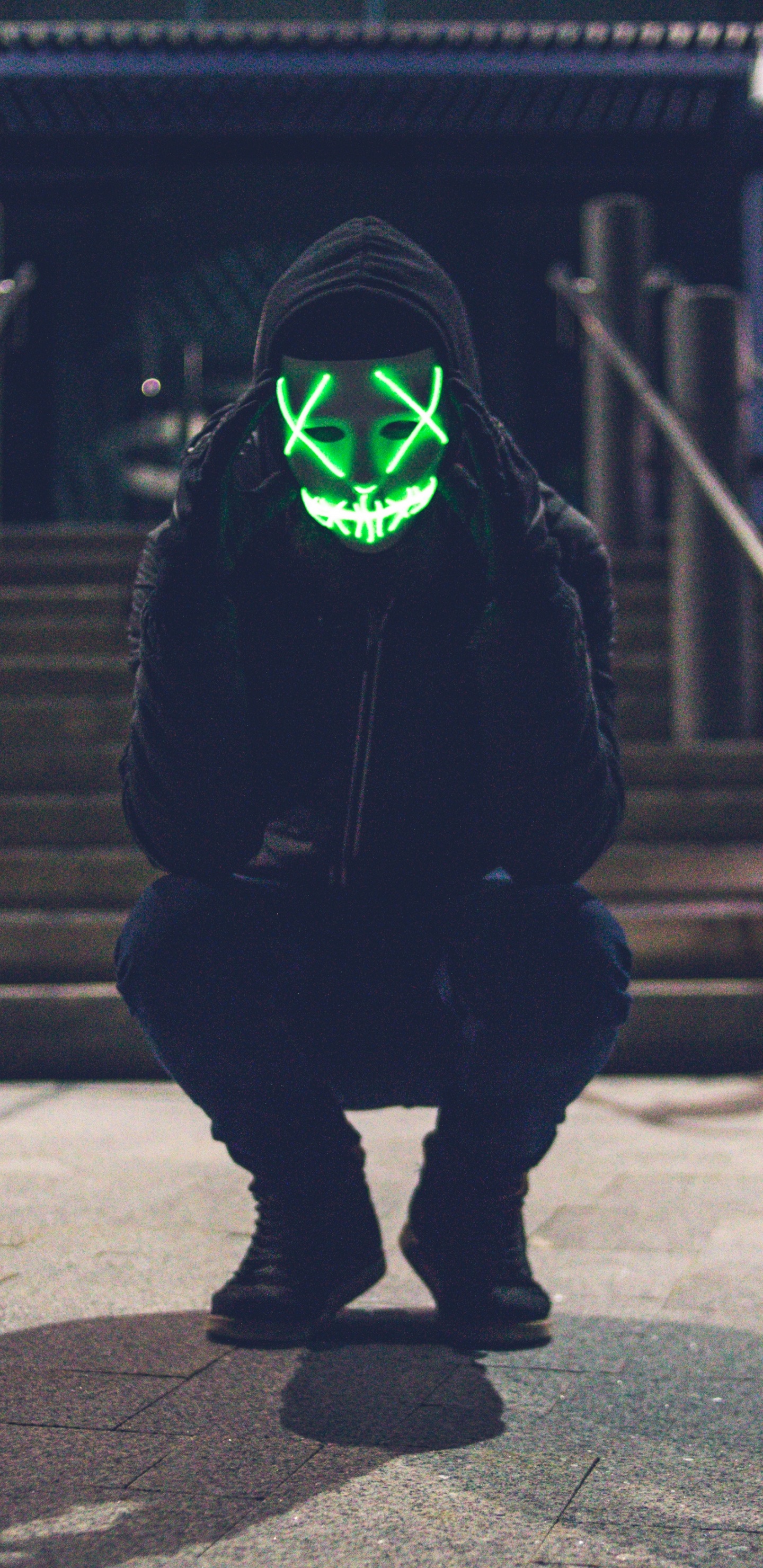 Person in Black Hoodie Wearing Green Mask. Wallpaper in 1440x2960 Resolution