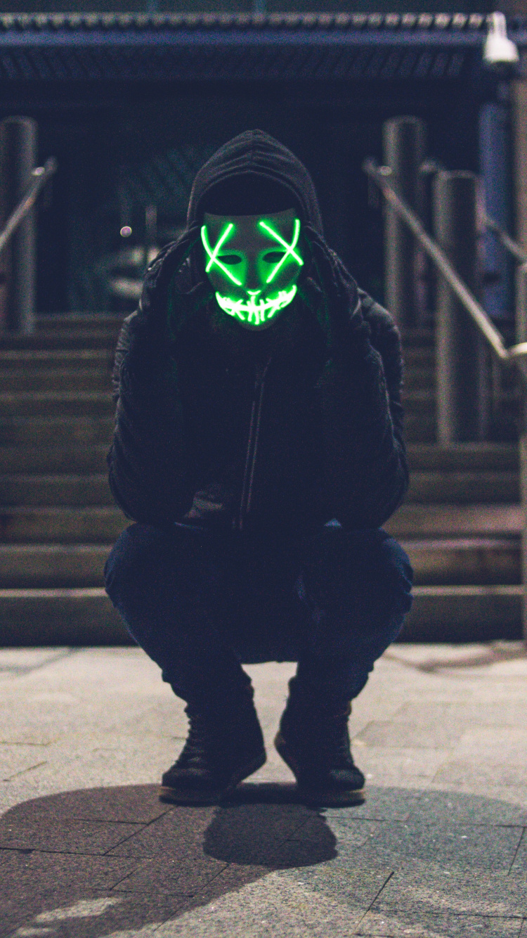 Person in Black Hoodie Wearing Green Mask. Wallpaper in 750x1334 Resolution