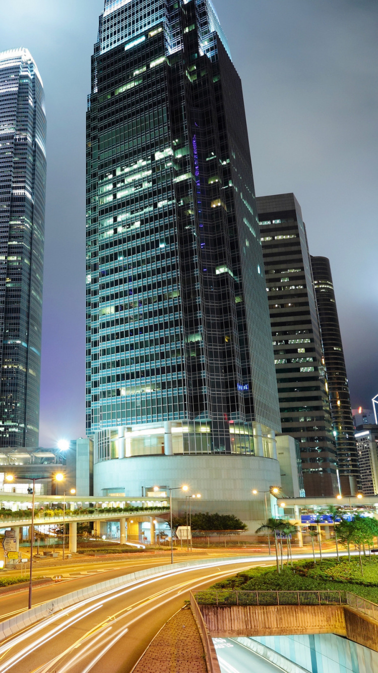 Cars on Road Near High Rise Buildings During Night Time. Wallpaper in 750x1334 Resolution