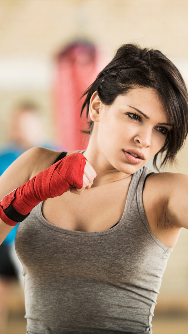 Woman in Gray Tank Top Wearing Red Gloves. Wallpaper in 750x1334 Resolution