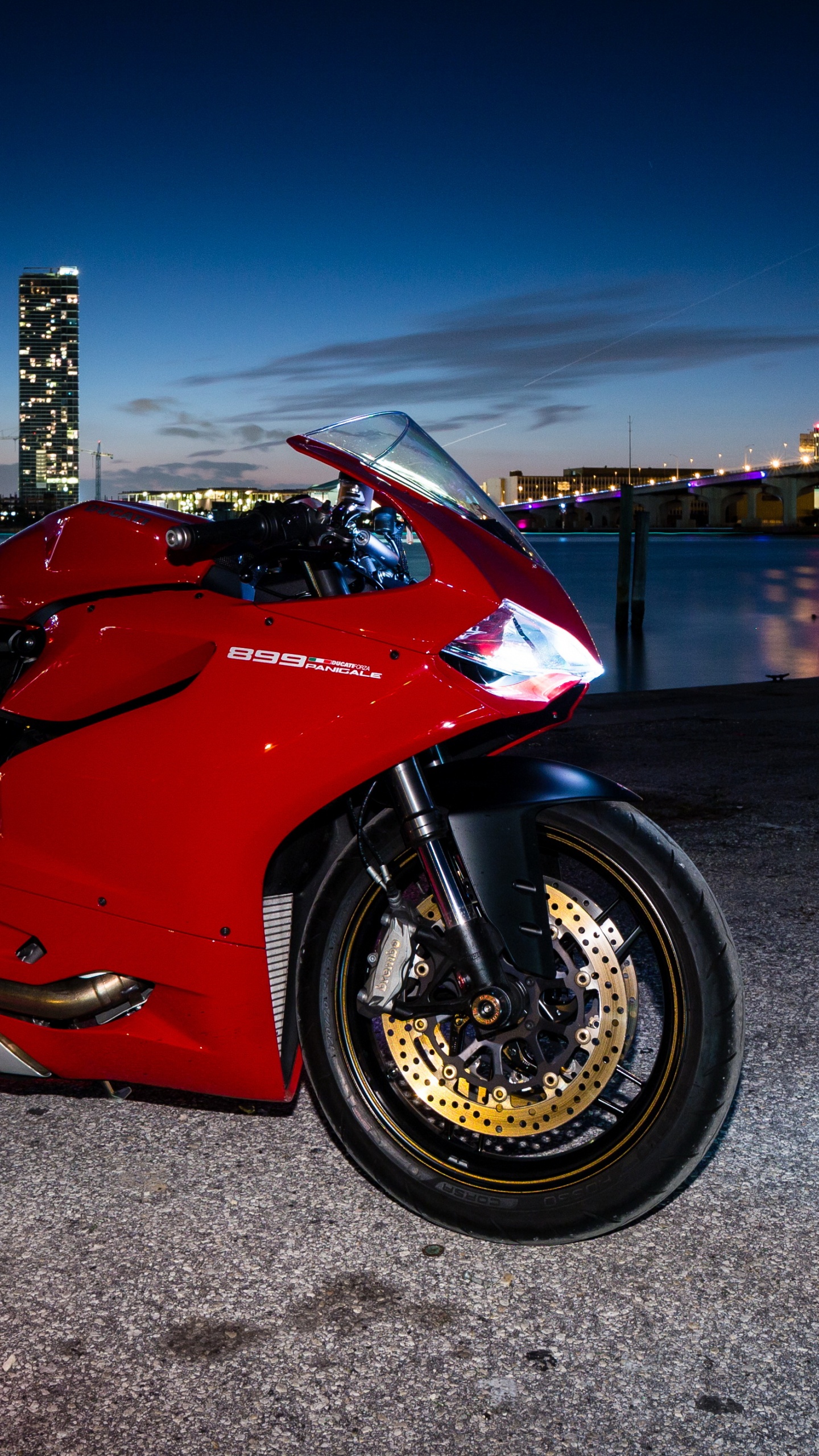 Red and Black Sports Bike Parked on Gray Concrete Pavement During Night Time. Wallpaper in 1440x2560 Resolution