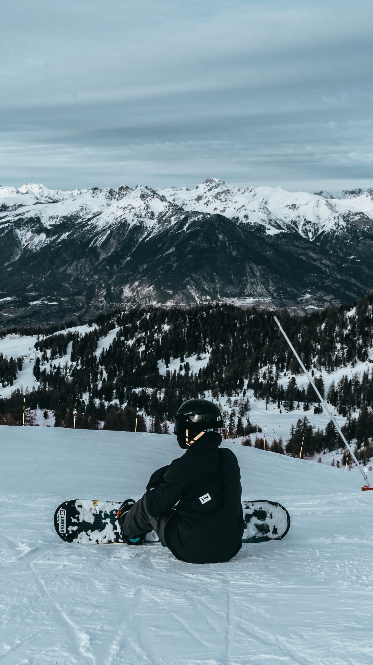 Man in Black Jacket Riding on Black Motorcycle on Snow Covered Mountain During Daytime. Wallpaper in 750x1334 Resolution