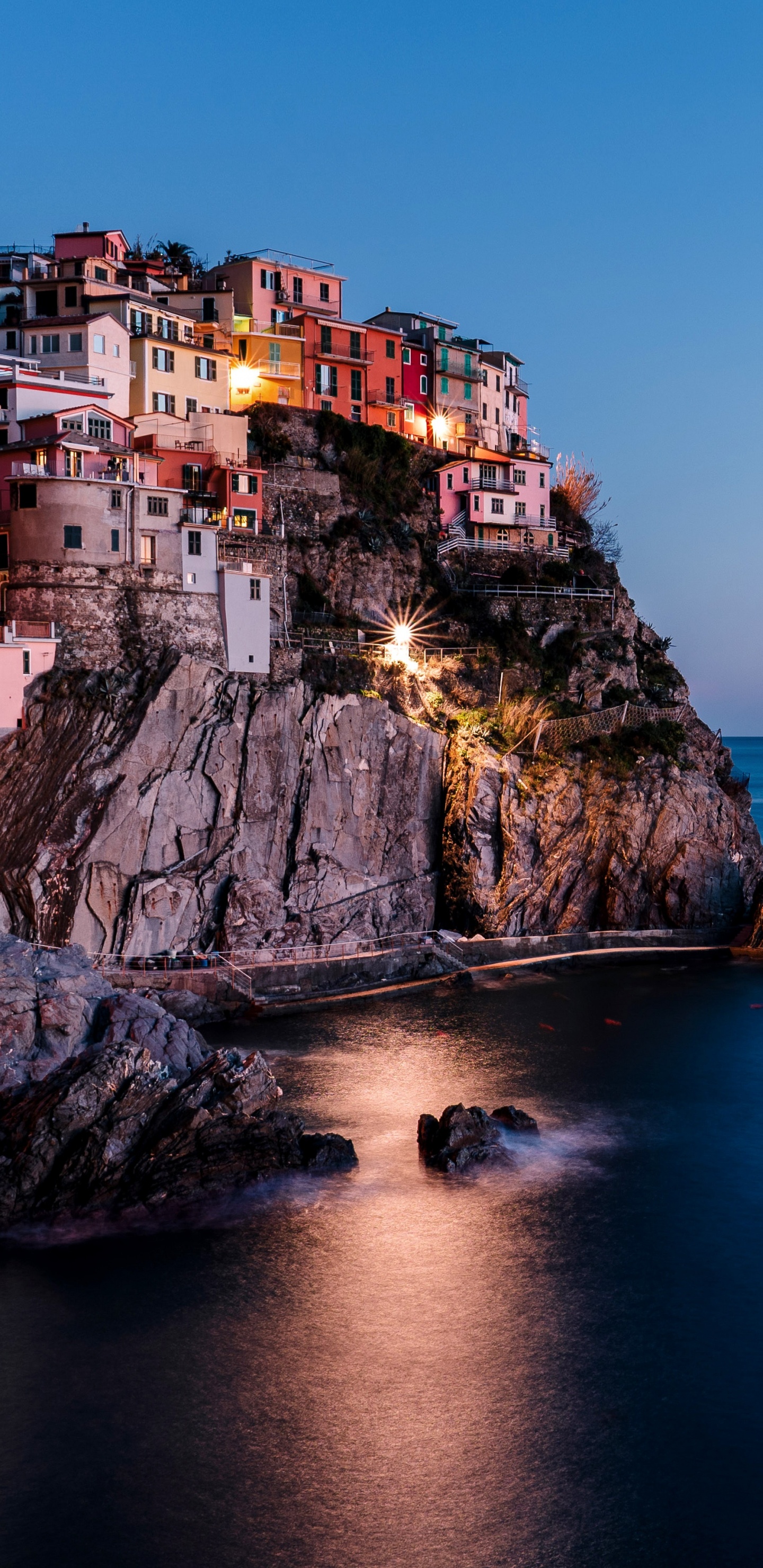 Brown Concrete Building Near Body of Water During Daytime. Wallpaper in 1440x2960 Resolution