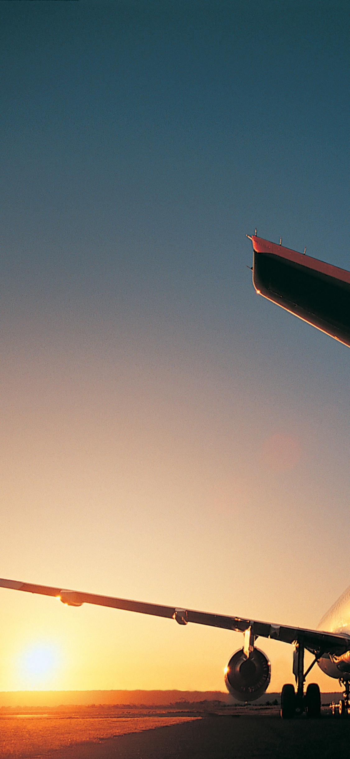 White and Red Airplane on Mid Air During Daytime. Wallpaper in 1125x2436 Resolution
