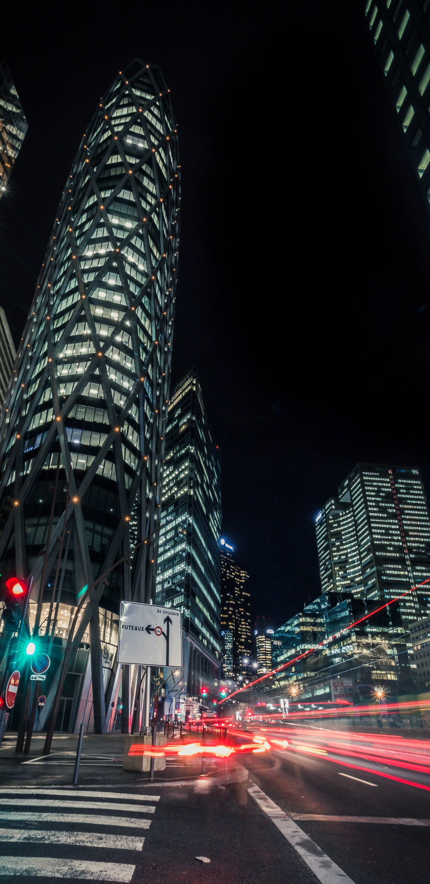 Cars on Road Near High Rise Building During Night Time. Wallpaper in 1440x2960 Resolution