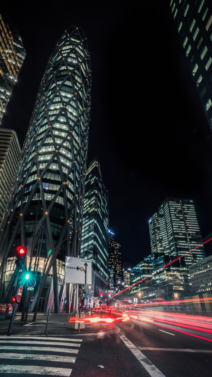 Cars on Road Near High Rise Building During Night Time. Wallpaper in 720x1280 Resolution