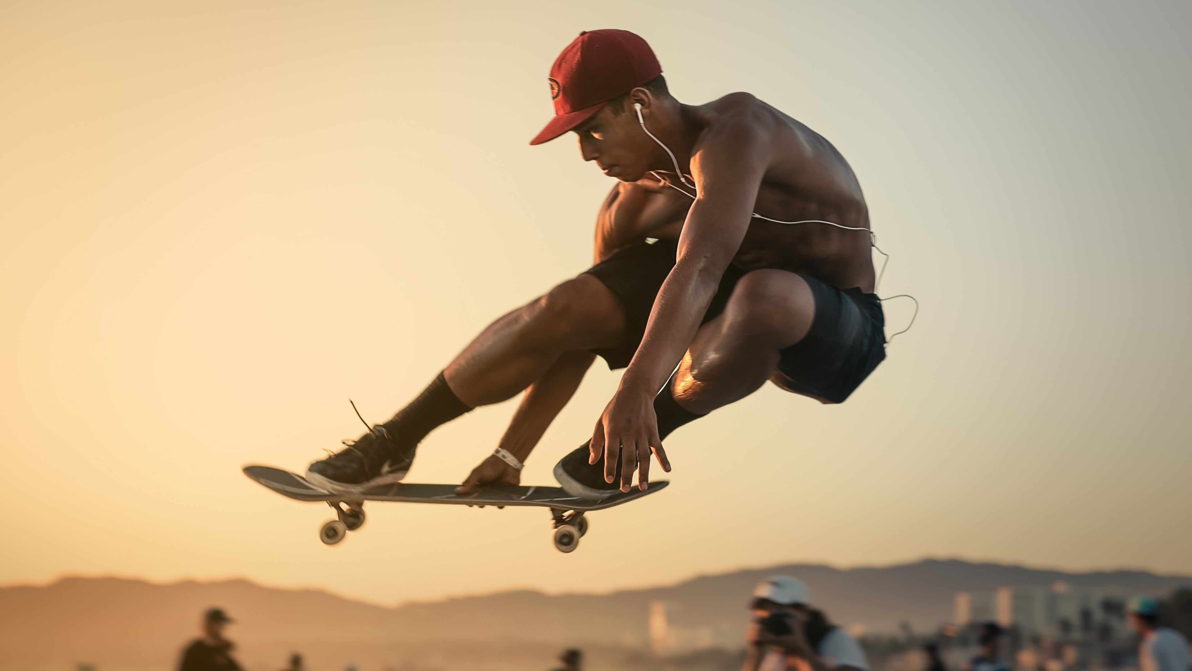Man in Red Cap and Blue Shorts Doing Stunts. Wallpaper in 3840x2160 Resolution