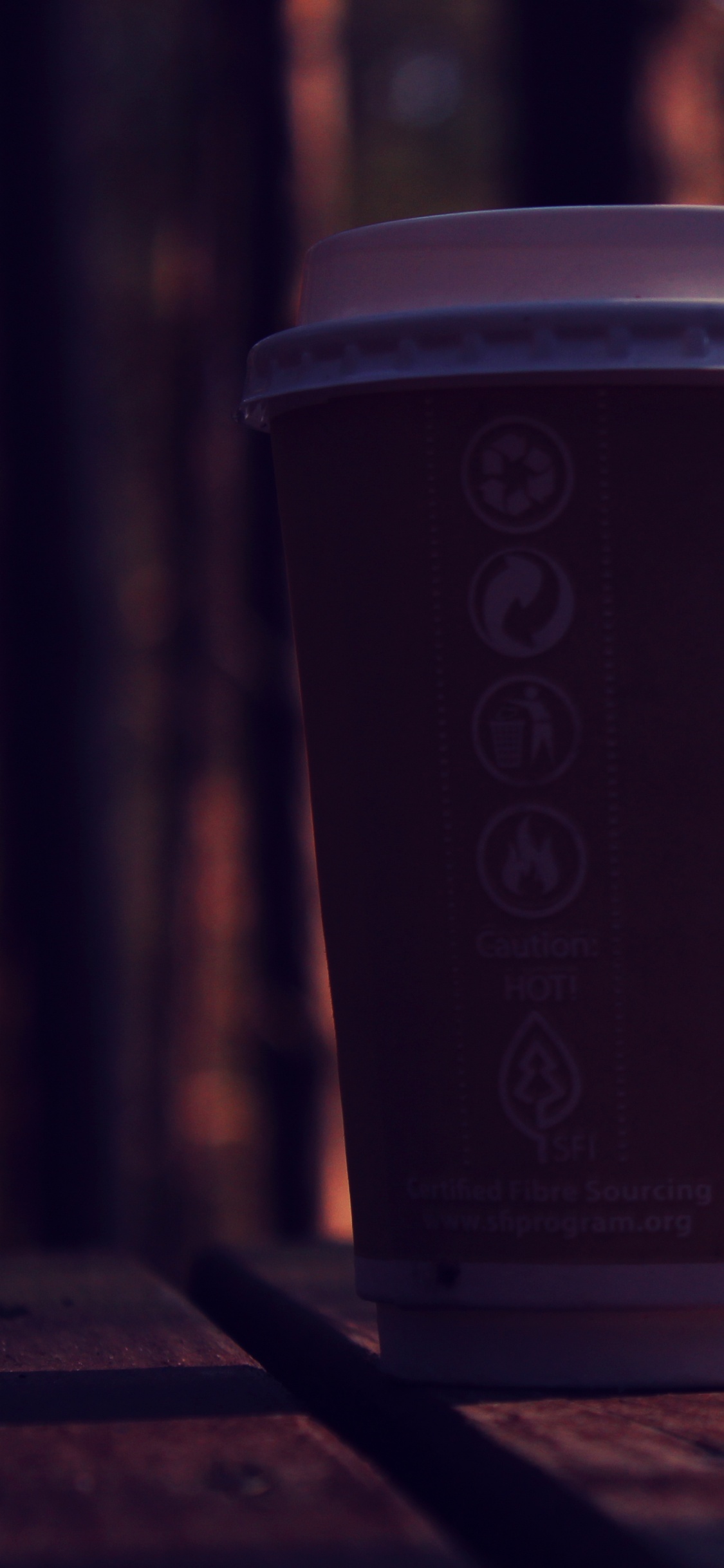 Brown and White Disposable Cup on Brown Wooden Table. Wallpaper in 1125x2436 Resolution