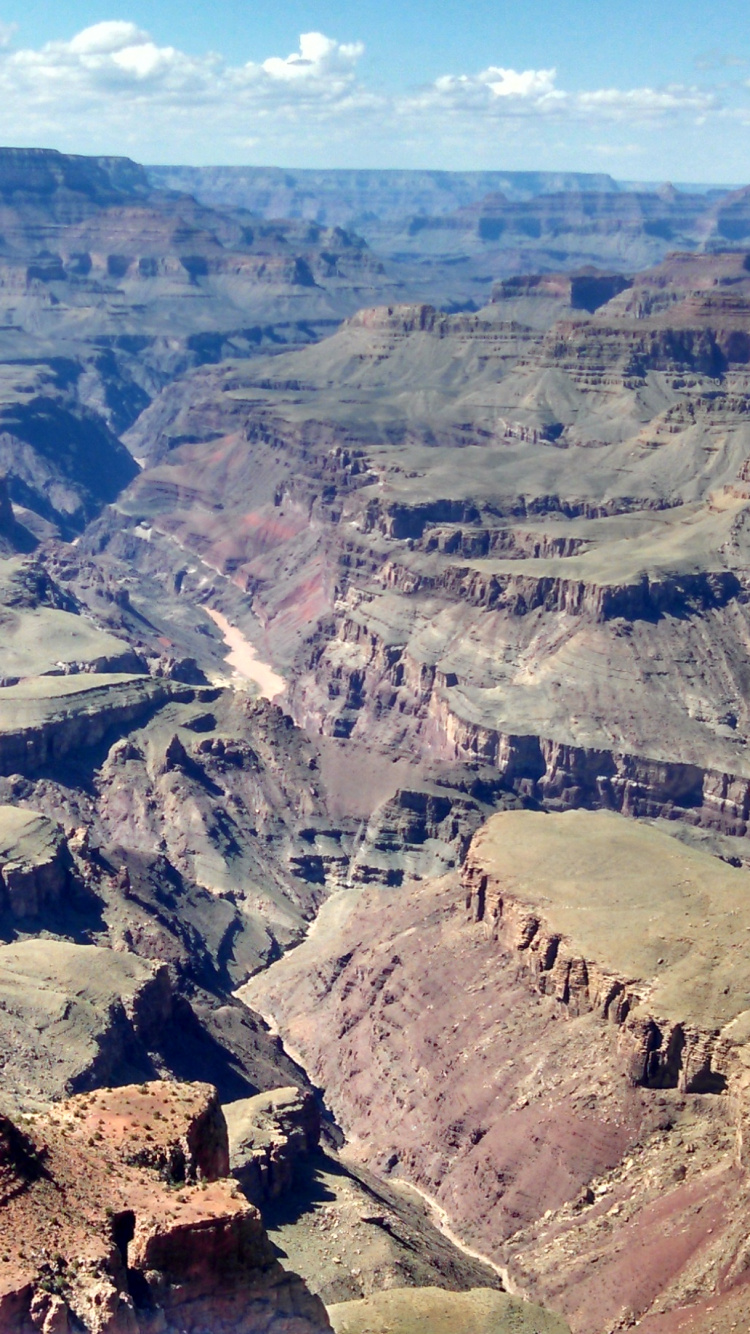 Brown Rocky Mountain Under Blue Sky During Daytime. Wallpaper in 750x1334 Resolution