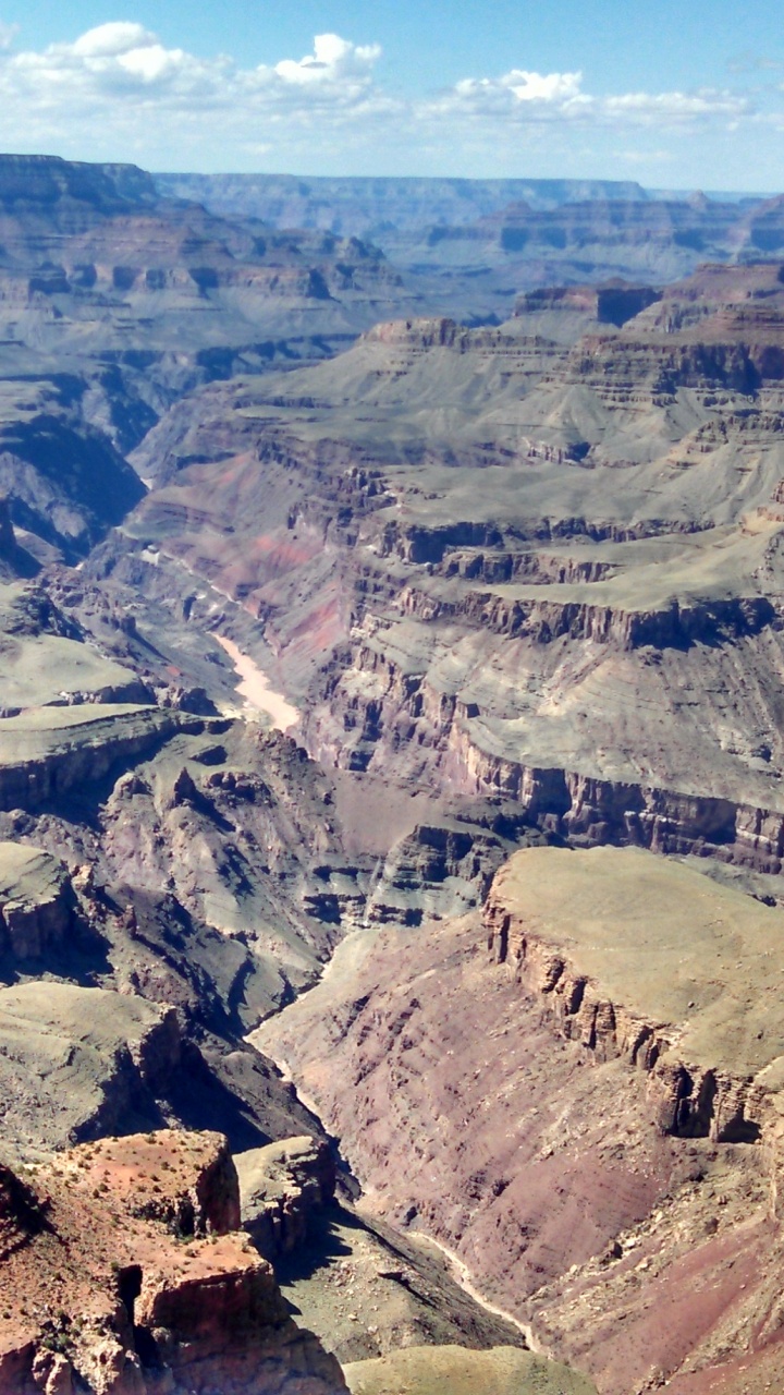 Montaña Rocosa Marrón Bajo un Cielo Azul Durante el Día. Wallpaper in 720x1280 Resolution