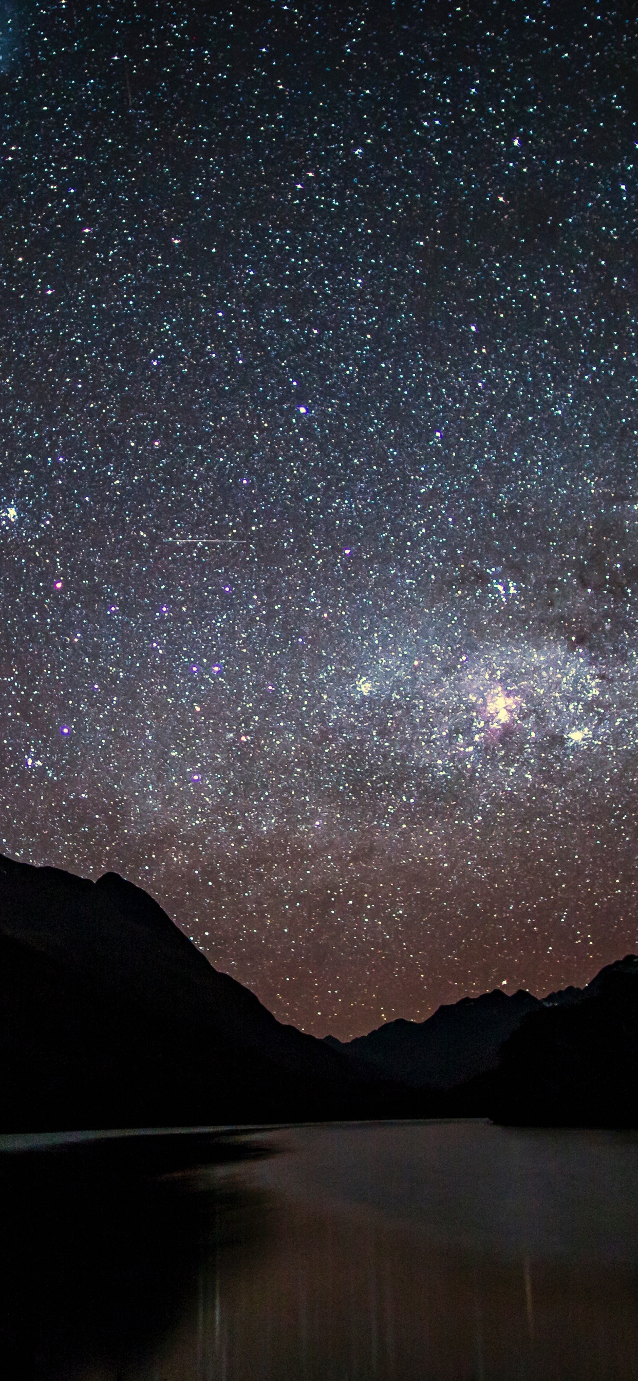 Body of Water Near Mountain Under Starry Night. Wallpaper in 1242x2688 Resolution