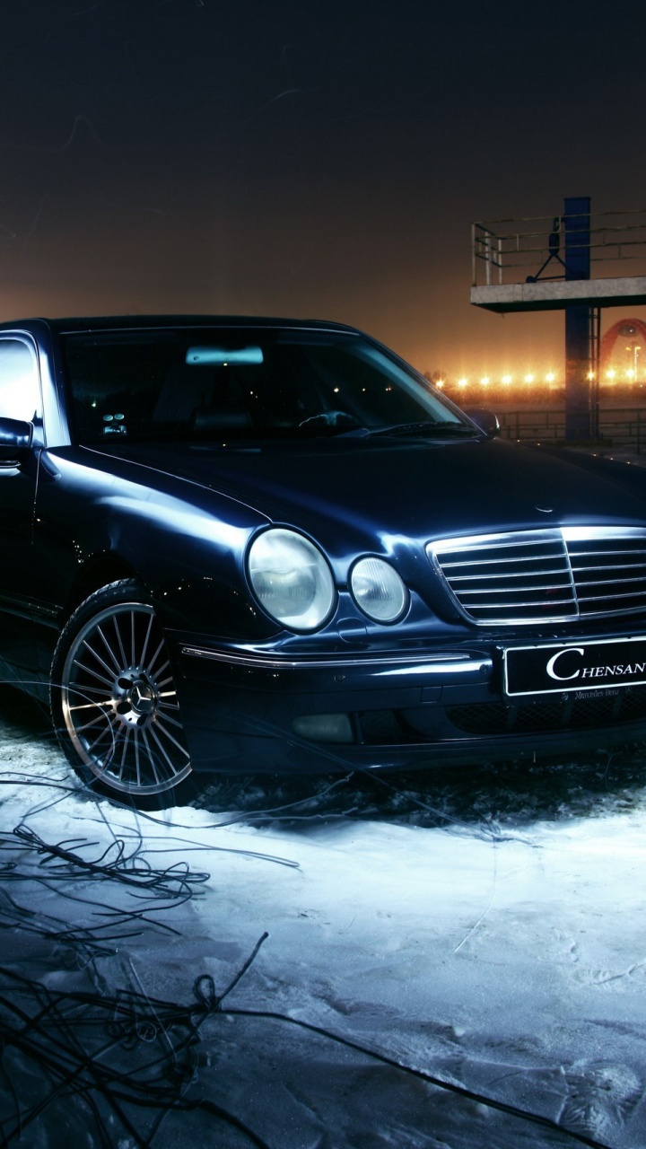 Black Mercedes Benz Coupe on Snow Covered Ground During Night Time. Wallpaper in 720x1280 Resolution
