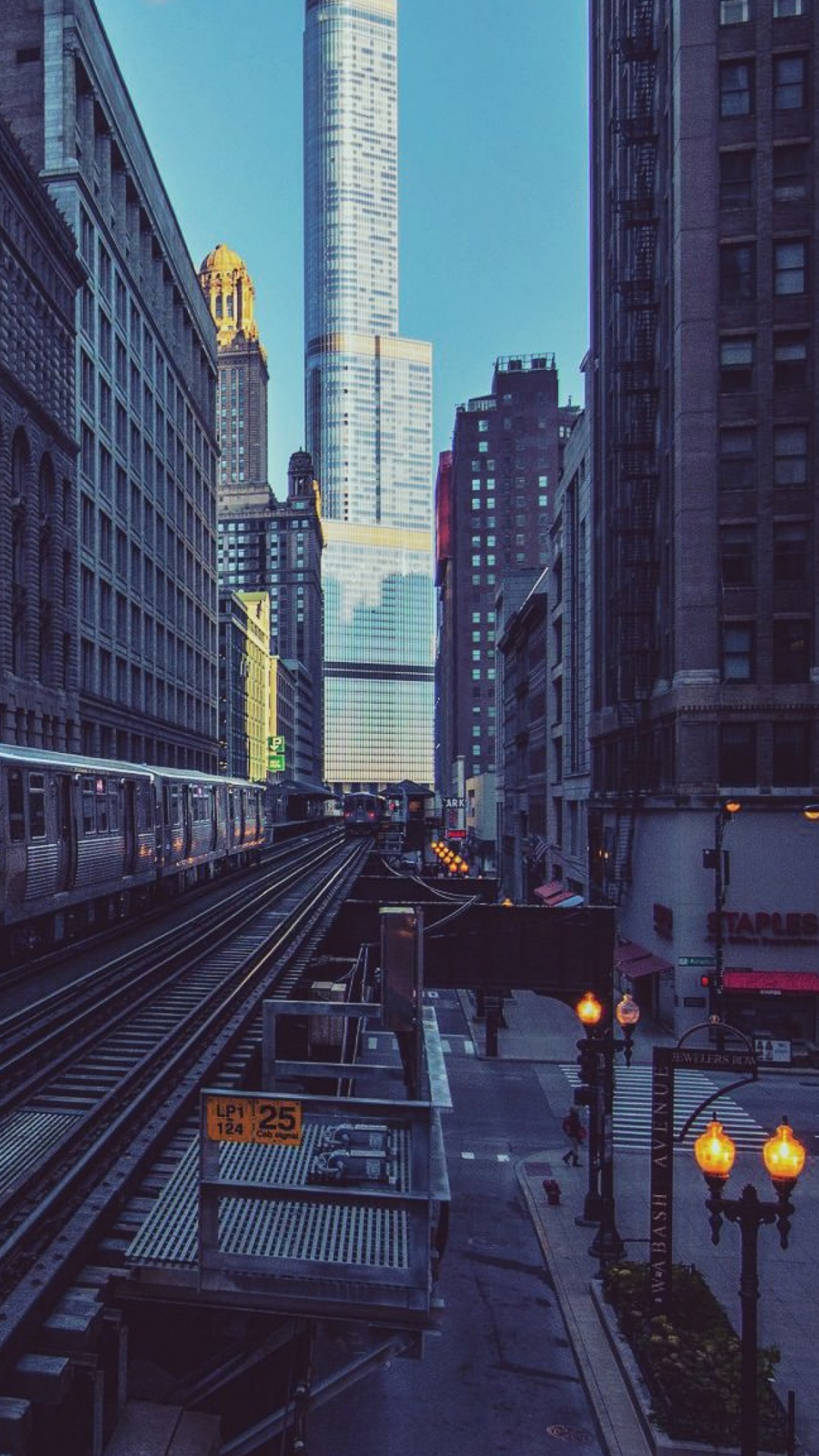 White and Black Train on Rail Road in Between High Rise Buildings During Daytime. Wallpaper in 1080x1920 Resolution