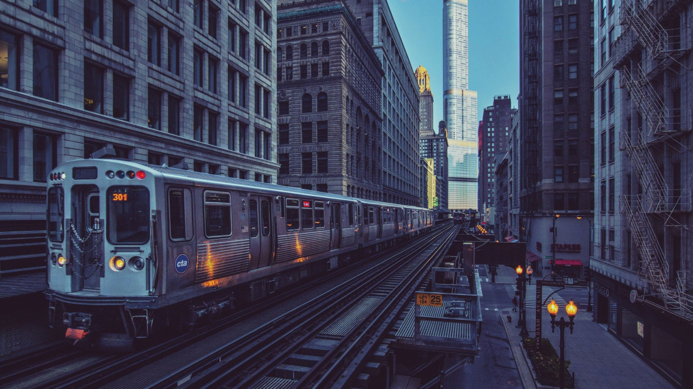 White and Black Train on Rail Road in Between High Rise Buildings During Daytime. Wallpaper in 1366x768 Resolution