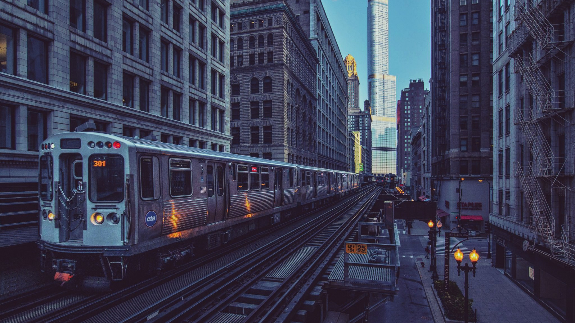 White and Black Train on Rail Road in Between High Rise Buildings During Daytime. Wallpaper in 1920x1080 Resolution