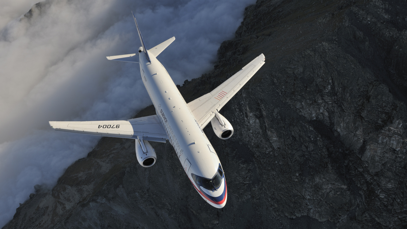 Weißes Und Rotes Flugzeug, Das Über Den Berg Fliegt. Wallpaper in 1366x768 Resolution