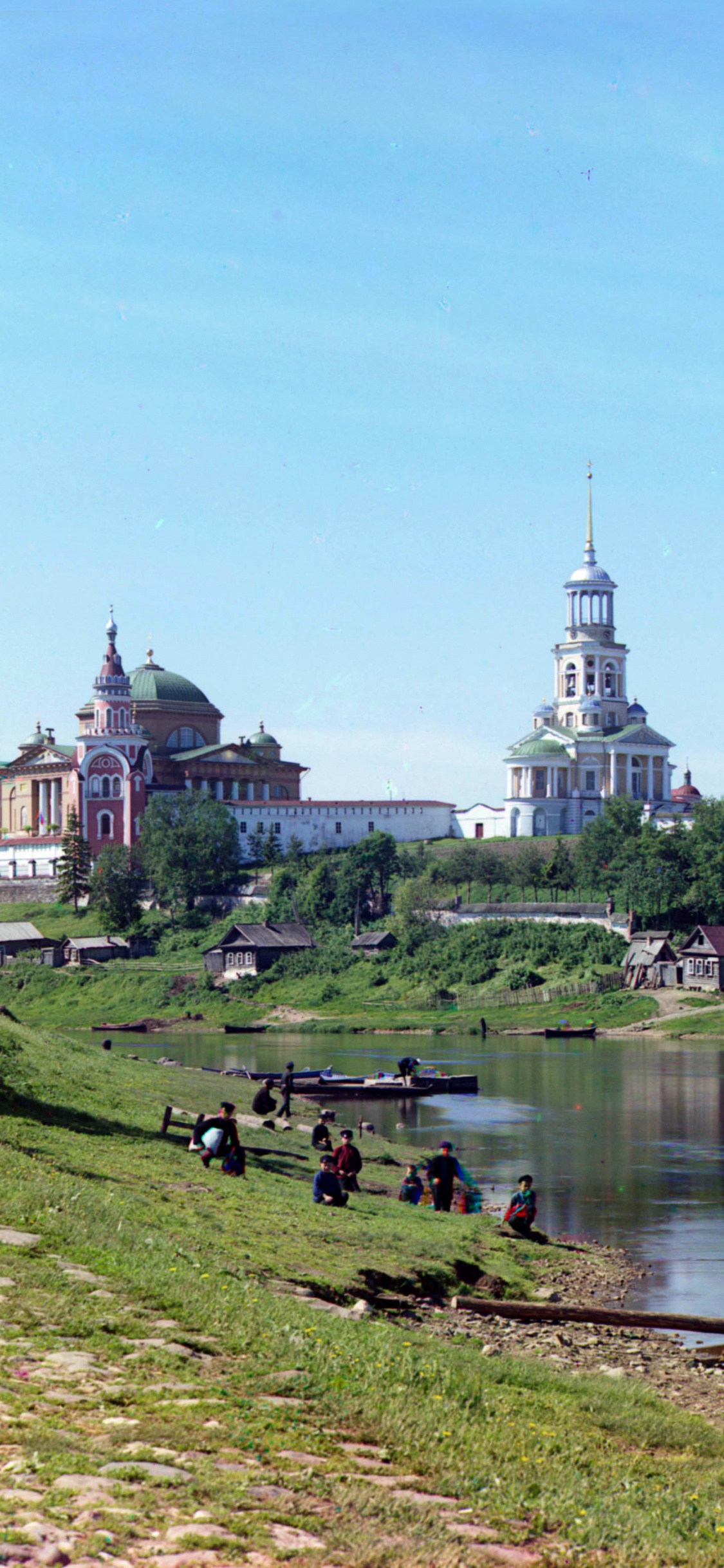 White Concrete Building Near River During Daytime. Wallpaper in 1125x2436 Resolution